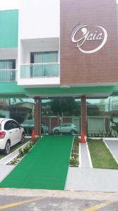 a building with a green carpet in front of it at Pousada Gaia in Macaé