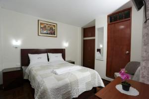 Ένα ή περισσότερα κρεβάτια σε δωμάτιο στο Witobi Hostal