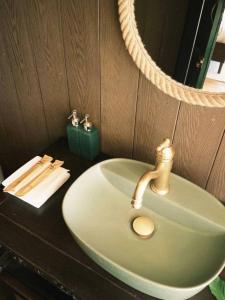 a bathroom sink with a faucet on a counter at Tropical eglamping in Tân Phú