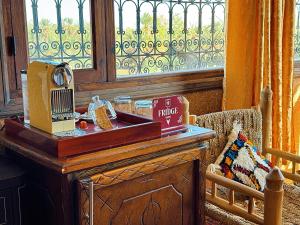 a wooden table with a sewing machine next to a window at Riad Chay & Boutique in Ouarzazate