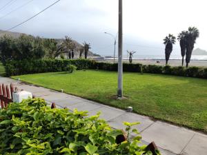 a park with the beach and palm trees and a pole at bungalows in Santa Rosa