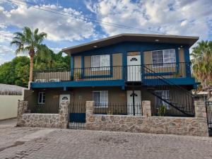 a house with a blue and brown at Casas centro Loreto in Loreto