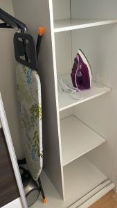 a surfboard is hanging on a shelf in a room at BT Lux apartment 2 in Skopje