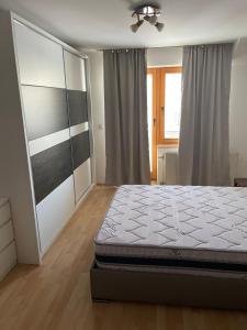 a bedroom with a bed and a window at BT Lux apartment 2 in Skopje
