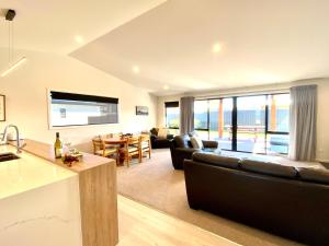 a large living room with a couch and a table at Four Lakes Retreat in Twizel