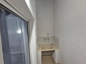 a bathroom with a sink next to a window at Departamentos Blazu Cafayate in Cafayate +12 photos