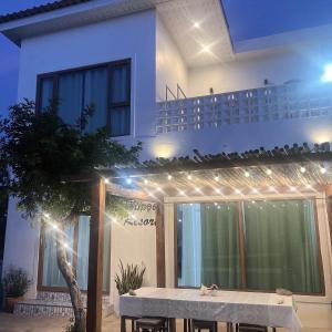 a table in front of a house at night at โอบกอด รีสอร์ท เกาะล้าน in Ko Larn