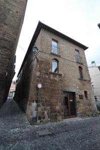 a large brick building with a red sign on it at Appartamento Mia in Orvieto