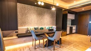 a dining room with a table and chairs and a couch at Leaf house in Toucheng