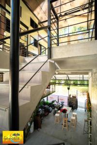 a staircase in a building with a table and chairs at La Zeblin Beach House in Zambales