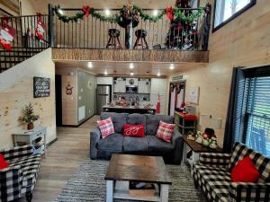 a living room with a couch and a table at Lil Cabin in the Cove! MTN views, theater, hot tub, games, king beds, Prime Location! in Sevierville