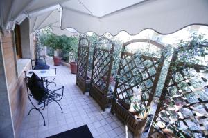a patio with an umbrella and some plants at Villa Alba Boutique Hotel in Pescara