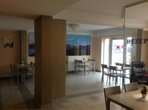 a living room with tables and chairs and a dining room at Pension an der Werft II in Rostock