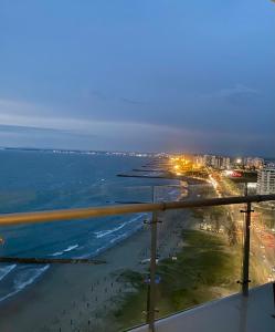 a view of a beach at night with the ocean at Paraíso frente al Mar Caribe en Cartagena. in Cartagena de Indias