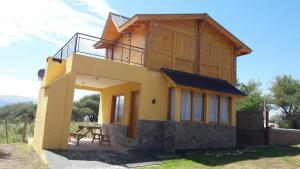 库拉布罗切罗镇Cabañas El Conejo Negro的前面有桌子的房子