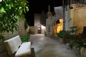 an empty alley with a bench in a building at night at Borgo Antico in Diso +16 photos