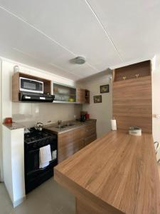 a kitchen with a stove and a counter top at Depto Centrico Exclusivo in Villa Carlos Paz