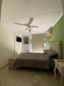 a bedroom with a bed and a ceiling fan at Depto Centrico Exclusivo in Villa Carlos Paz