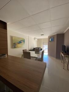 a living room with a table and chairs and a desk at Depto Centrico Exclusivo in Villa Carlos Paz