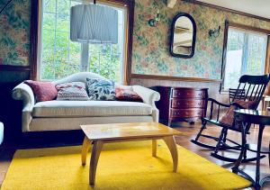 a living room with a couch and a table at Miles Town in Ito