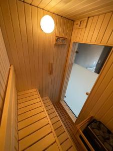 an overhead view of a small room with a door and stairs at furano Hokuseisanso I in Furano
