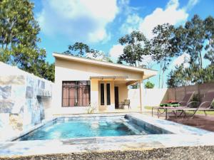 a villa with a swimming pool in front of a house at Lisa Loft Boutique Apartment in Fortuna