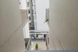 a view of a building from the hallway of a building at Cozy and Minimalist Studio (No Kitchen) at Aeropolis Apartment By Travelio in Tangerang