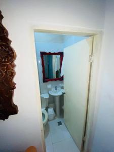 a small bathroom with a toilet and a sink at Habitaciones independientes con baño privado #6 in Cartagena de Indias +3 photos