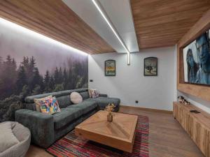 a living room with a couch and a coffee table at Chalet à Méribel, jacuzzi, sauna, 5 chambres, 14 pers. - FR-1-566-73 in Les Allues