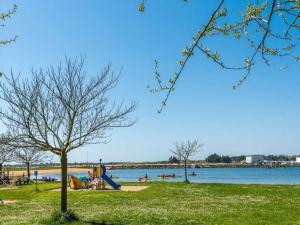 a park next to the water with a playground at Étel - Appartement 2 pièces - 42 m² - Vue mer - Wifi - Animaux admis - Parking - FR-1-479-165 in Étel +2 photos