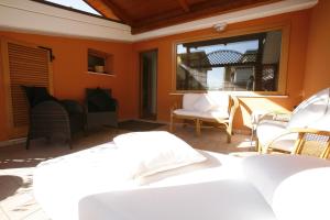 a patio with chairs and a table and a window at Villa Alba Boutique Hotel in Pescara