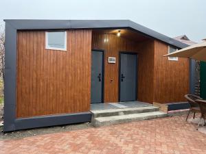 a small building with two doors and a patio at 51 guest house in Bishkek
