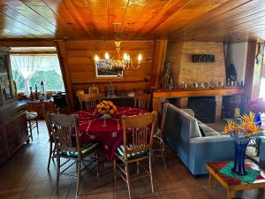 a dining room with a table and a fireplace at Villa San Francisco in Valle de Bravo