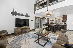 a living room with a couch and a tv at Hillside Haven in Lead