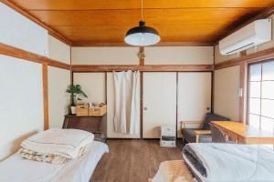 Postel nebo postele na pokoji v ubytování yururito guesthouse