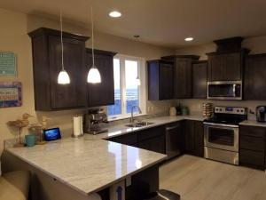 a kitchen with wooden cabinets and a counter top at Beach Escape in Waldport
