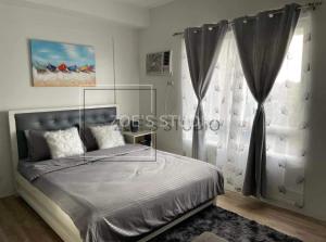 a bedroom with a bed and a window at Zoe Studio Mesavirre in Bacolod +27 photos
