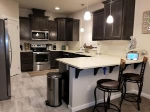 a kitchen with brown cabinets and a white counter top at Sail Away in Waldport