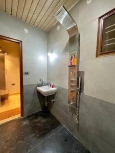 a bathroom with a sink and a mirror at Ultra Luxurious 4 Floor Villa in Bengaluru