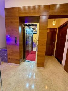 a room with a glass door with a red couch at Ultra Luxurious 4 Floor Villa in Bengaluru