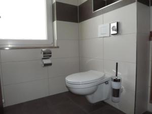 a bathroom with a white toilet and a window at Hotel zum Weissen Ochsen in Aalen +22 photos
