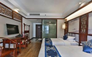 Zhangjiajie Huan Sha Ju Hotel的电视和/或娱乐中心