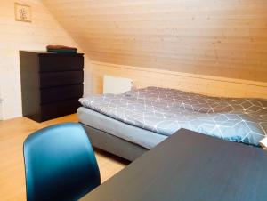 a bedroom with a bed and a table and a blue chair at Sowi Stok in Sokolec +57 photos