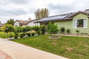 a house with a green yard with trees and bushes at Goode Homes Luxury Family Home in Granada Hills