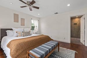 a bedroom with a bed with a ceiling fan at Goode Homes Luxury Family Home in Granada Hills