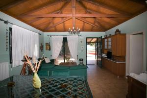 a living room with a green couch and a vase on a table at Asterias Home Kefalonia in Lixouri