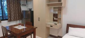 a small room with a table and a bed at Le Chateau Residences in Bacolod