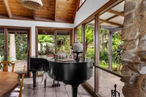 a house with a piano in a room with windows at Stunning Cabin Retreat By The Sea in Scarborough