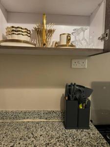 a kitchen counter with a knife holder on a counter top at karibu homes, epic brownstone phase 1 in Nairobi