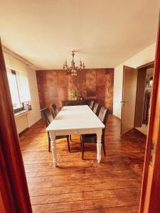 a dining room with a white table and chairs at Monteurzimmer in Troisdorf